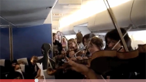 Stranded Orchestra Gives Impromptu Inflight Concert For Fellow Passengers