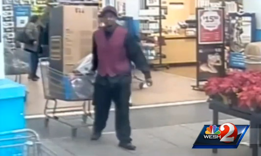 Anti-Santa takes his toy haul from the store while people tend to his alleged accomplice