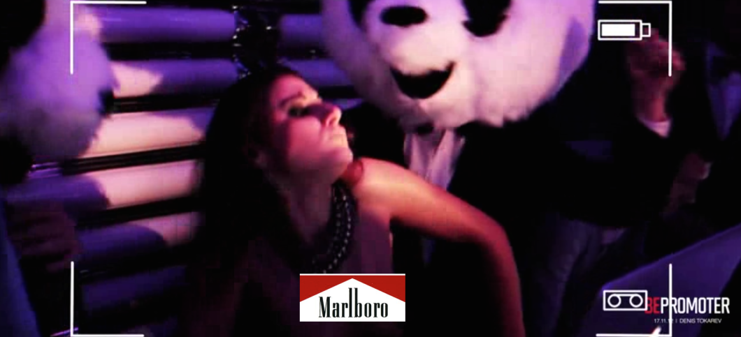 Several minutes of the Moldova video feature this topless dancer grinding on the panda-headed DJs. The Marlboro logo in the image above was inserted to cover her bare, pierced nipples.