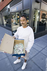 Don't Keep Your Money In A Shoebox, Or At Least Don't Pose For A Photo With It