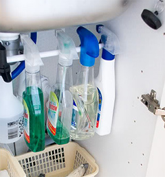 Organize Spray Bottles Under Sink With A Tension Rod