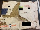 Here Are The Tattered Remains Of An Attempt To Mail Some Textbooks