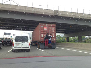 Motorists Snap Pictures Of Idiots On Back Of Tractor-Trailer, Don’t Call Police