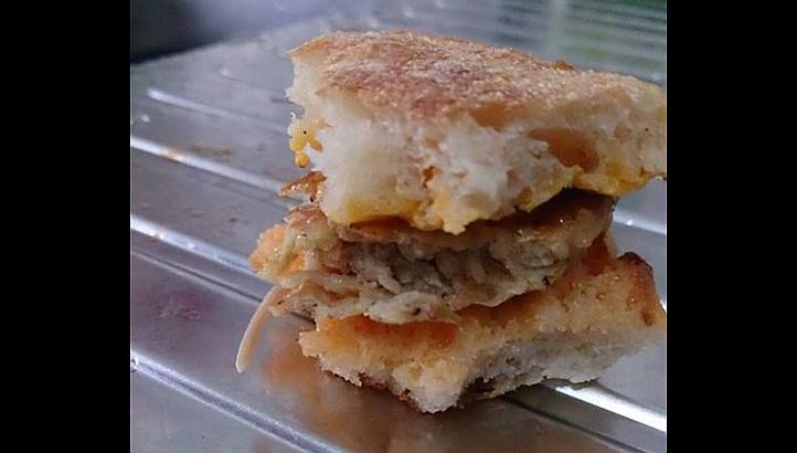 A McDonald's customer in Singapore believed that the long, dangling whitish thing in this sausage sandwich was a baby lizard.