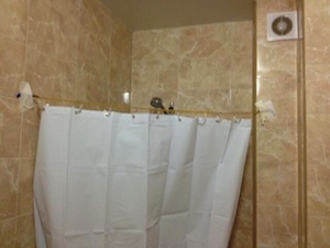 Olympics Reporter Uses Clothesline & Tape To Deal With Lack Of Shower Curtain