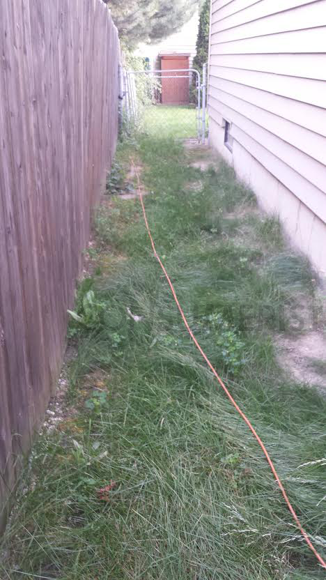 The orange cable isn't even buried. It runs  through the yard to a neighboring property.