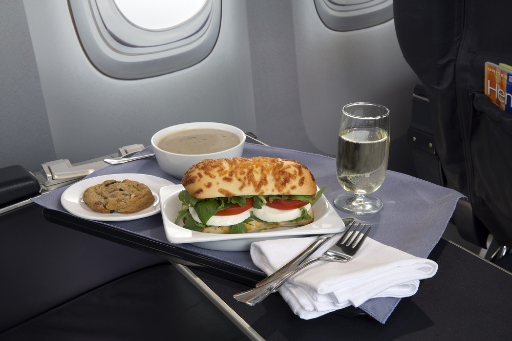 One of United's new meal options for first class passengers includes a caprese on asiago baguette sandwich - and Italian wine.  Photo courtesy of United Airlines. 