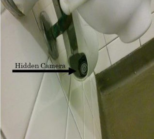 Woman being caught on hidden camera in bathroom